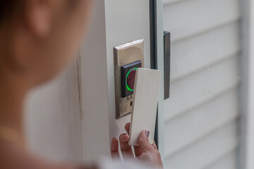 Hand Holding Key card Hotel room access.