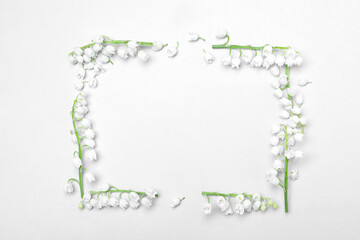 Frame made with lily of the valley flowers on light grey background, flat lay. Space for text