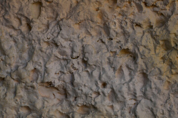 Blurred abstract background. Rough brown surface of cement wall. Old painted wall with cracks. Horizontal, closeup, free space. Construction and design concept.
