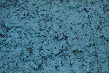 Blurred abstract background. Rough blue surface of a cement wall. Old painted wall with cracks. Horizontal, close-up, free space. Construction and design concept.