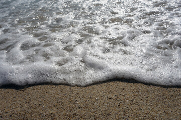 Sea wave and sandy beach.