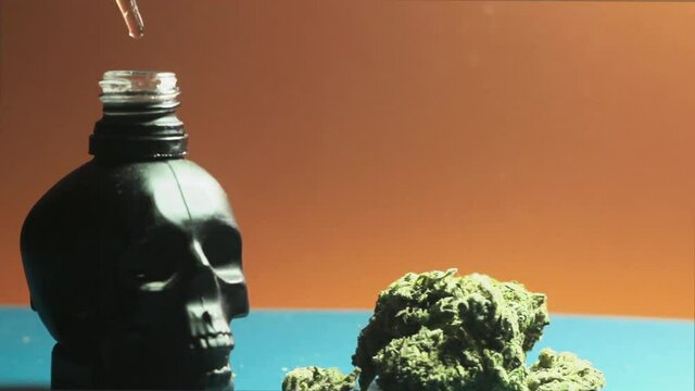Drips Of CBD Oil Drops Into The Bottle From Pipette. New Product For Vape With Liquid Cannabinoids