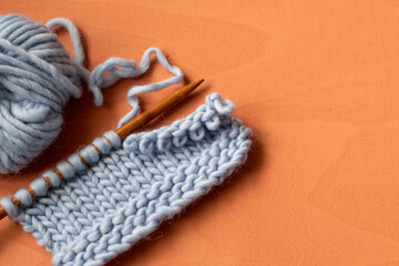 Fototapeta na wymiar blue knitting on needles