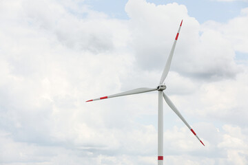 Modern wind turbine against cloudy sky, closeup. Alternative energy source