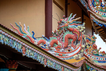 Colorful dragon sculpture on the roof In a Buddhist temple in Danang, Vietnam