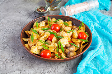 Stir fry farfalle pasta with vegetables, cauliflower and mushrooms