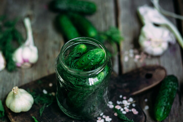 Recipe for pickling cucumbers. Jar with cucumbers on a wooden table