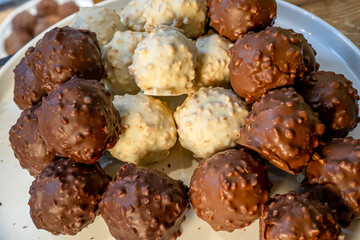 Black, white and milk chocolate on the white background. Macro close of french chocolate. Fresh organic nut.