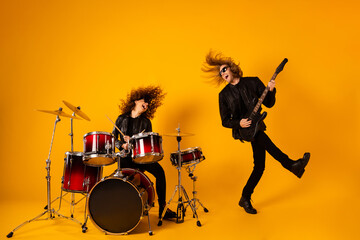 Full length photo funky crazy two people popular rock team man play bass guitar girl drum enjoy...