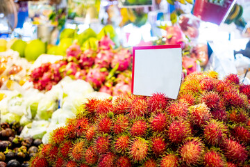 Fresh rambutans with blank space paper price tag at Thai fresh market
