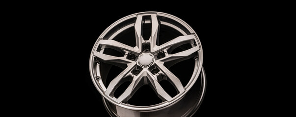 silver SUV Allloy wheel, close-up on a black background