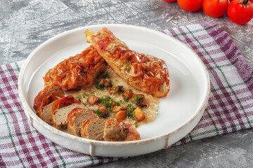 Chicken drumstick ballotin with onion sauce and mushrooms. Stuffed chicken legs