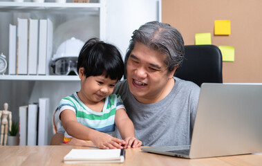 Asian father is work at the home with a daughter and studying online learning from school together. New lifestyle normal during a quarantine. Concept of stay home, freelance and fatherhood concept