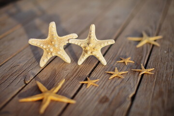Starfish on a wooden pier poured over a wooden deck. Summer vacation concept. Holidays by the sea
