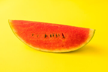 Fototapeta na wymiar Fresh ripe watermelon slice on yellow background.