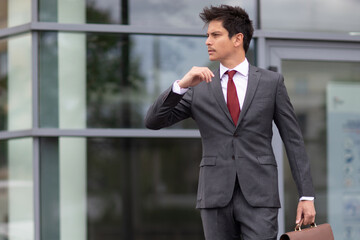 a man in a suit posing outdoors