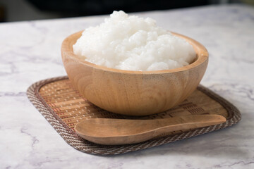rice gruel or rice porridge in a wooden bowl.