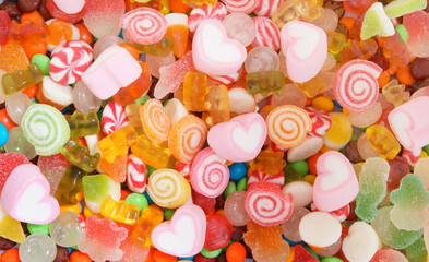 Mixed colorful fruit candies and marshmallow as background