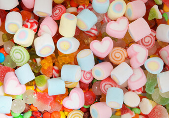 Mixed colorful fruit candies and marshmallow as background