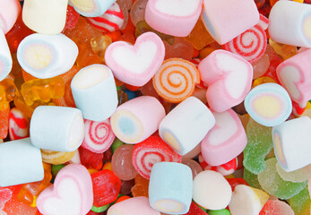 Mixed colorful fruit candies and marshmallow as background