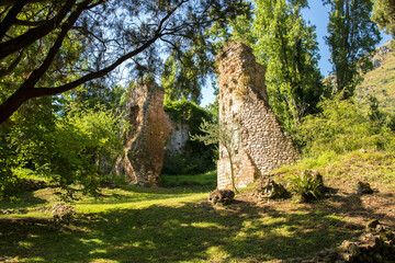 Ruins of Ninfa, an ancient medieval town located in the province of Latina, Italy. Now it is part of the complex of Ninfa gardens. - obrazy, fototapety, plakaty