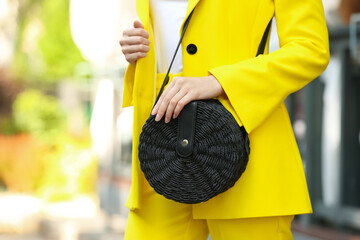 Young woman with stylish handbag outdoors on summer day, closeup