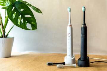 Modern black and white sonic or electric whitening toothbrush set. Concept of professional oral...