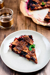 Delicious homemade berries honeysuckle pie on wooden table. Selective focus