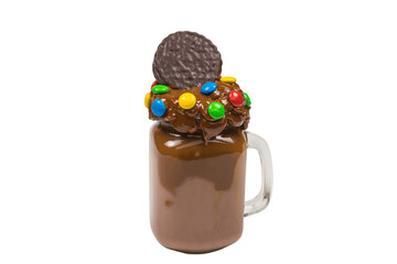 Chocolate milkshake with whipped cream, cookies, waffles, served in glass mason jar. 