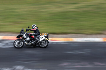 motorcyclist speed blur on a race track