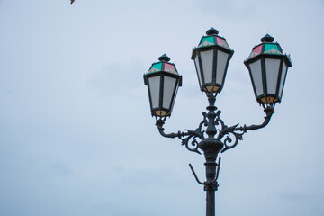 Fototapeta na wymiar regal street lamps against a cloudy sky
