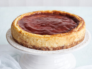 whole cheese cake with strawberry jam on top