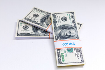 Set of a packs of dollars with a rubber band isolated on a white background
