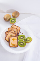 Beautiful photography kiwi plum cake, ripe kiwi , white plate, white background