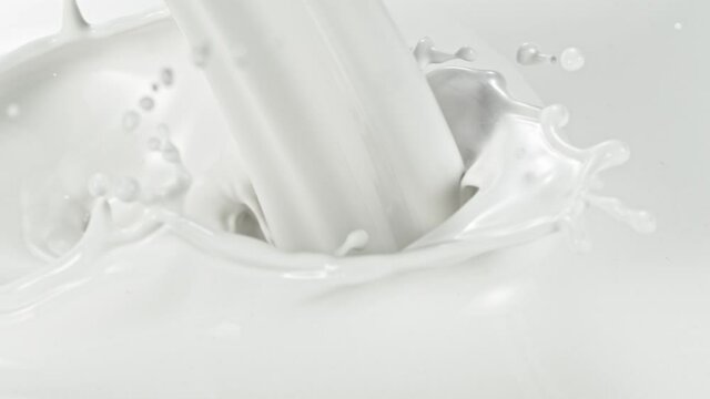 Super slow motion of pouring milk stream, macro shot. Filmed on high speed cinema camera, 1000fps.