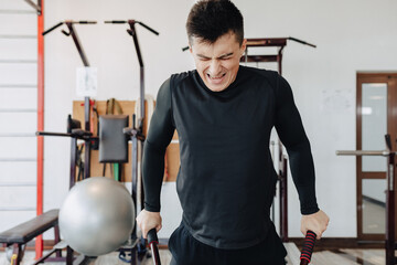 sports guy squeezes on bars, exercises on pectoral muscles. healthy lifestyle.