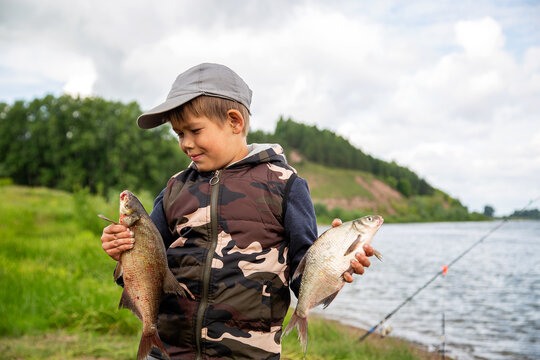 Seven Year Old Boy Holds A Fish He Caught