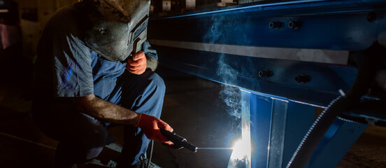 Close up of the welder that welds metal bar at the factory