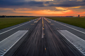 Used concrete asphalt airport empty runway with many braking marks, markings for landings and all...