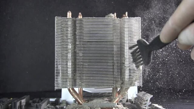 Dust pollution. Cleaning the processor radiator sink from dust. Antistatic brush. Slow motion.