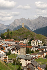 Fototapeta na wymiar Small Ardez village, Scuol municipality, with the Swiss Alps and the ancient ruins of the Medieval Castle Steinsberg. Engadin valley, Graubunden canton, Switzerland, Europe