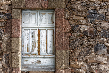 Old stone wall with shuttered wooden window - 361804630
