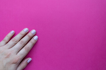Stylish trendy female manicure. Beautiful young woman's manicure on pink background.