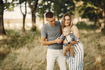 Family with cute little son. Father in a gray shirt. Lady in a dress