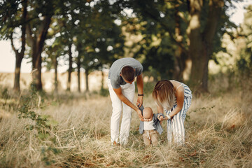 Family with cute little son. Father in a gray shirt. Lady in a dress
