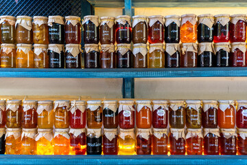 Colorful jams in glass jars.