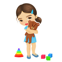 Cute little girl hugs a teddy bear, lying next to another children's toys