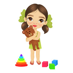 Cute little girl hugs a teddy bear, lying next to another children's toys