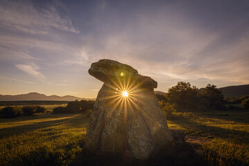 Sun in the middle of a dolmen hole naturally