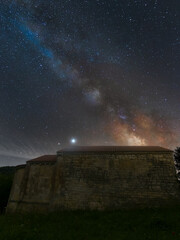 Fototapeta na wymiar Milky Way on an old hermitage of Romanesque art in the middle of the night